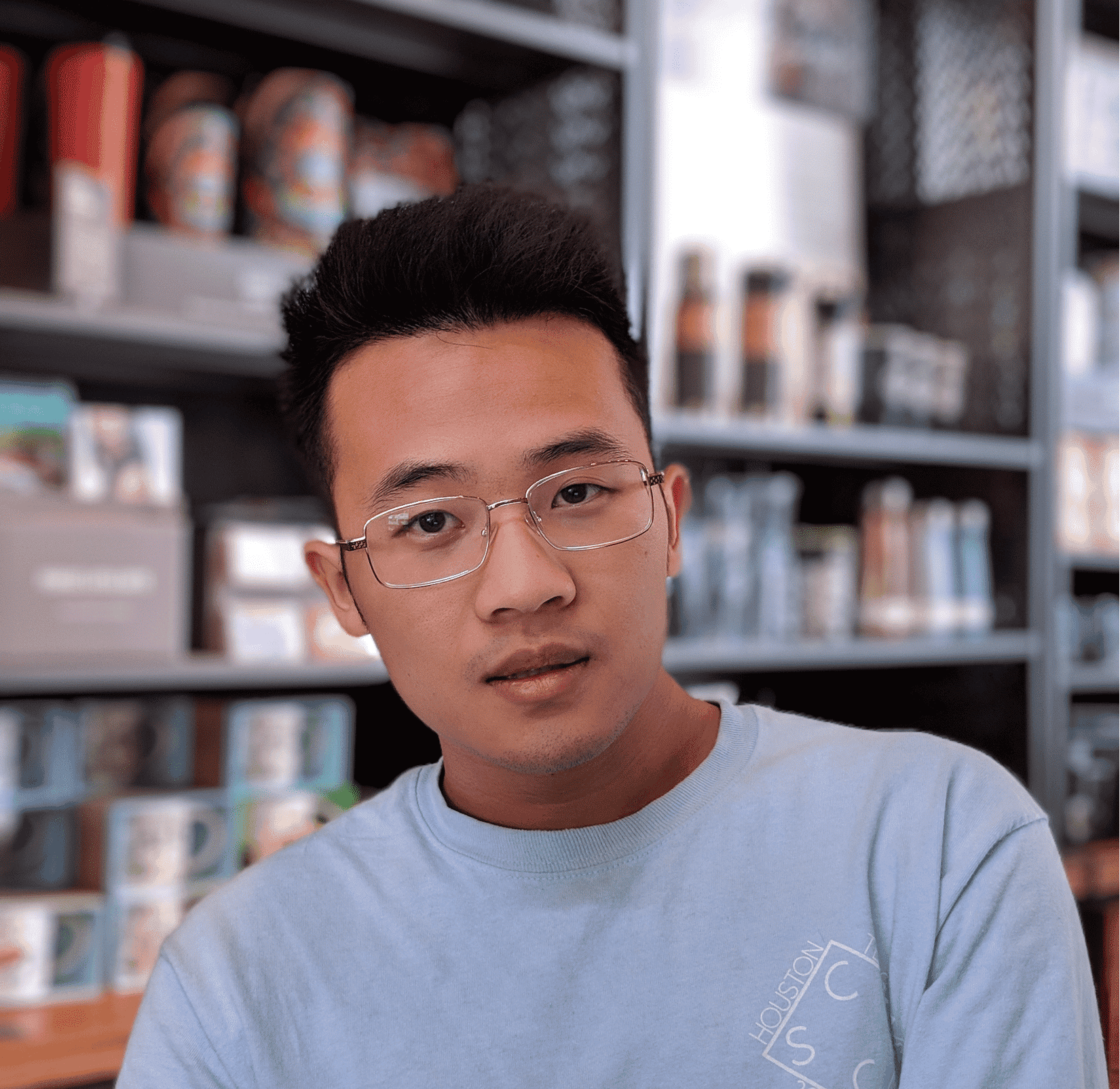 An asian man looking at the camera