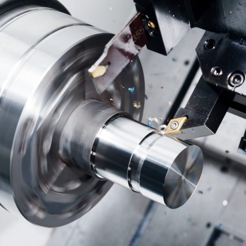 A CNC turning machine working on a piece of metal