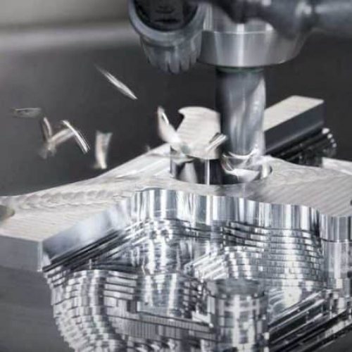 A CNC milling machine with fragments falling away