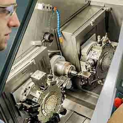 A man operating a CNC machine